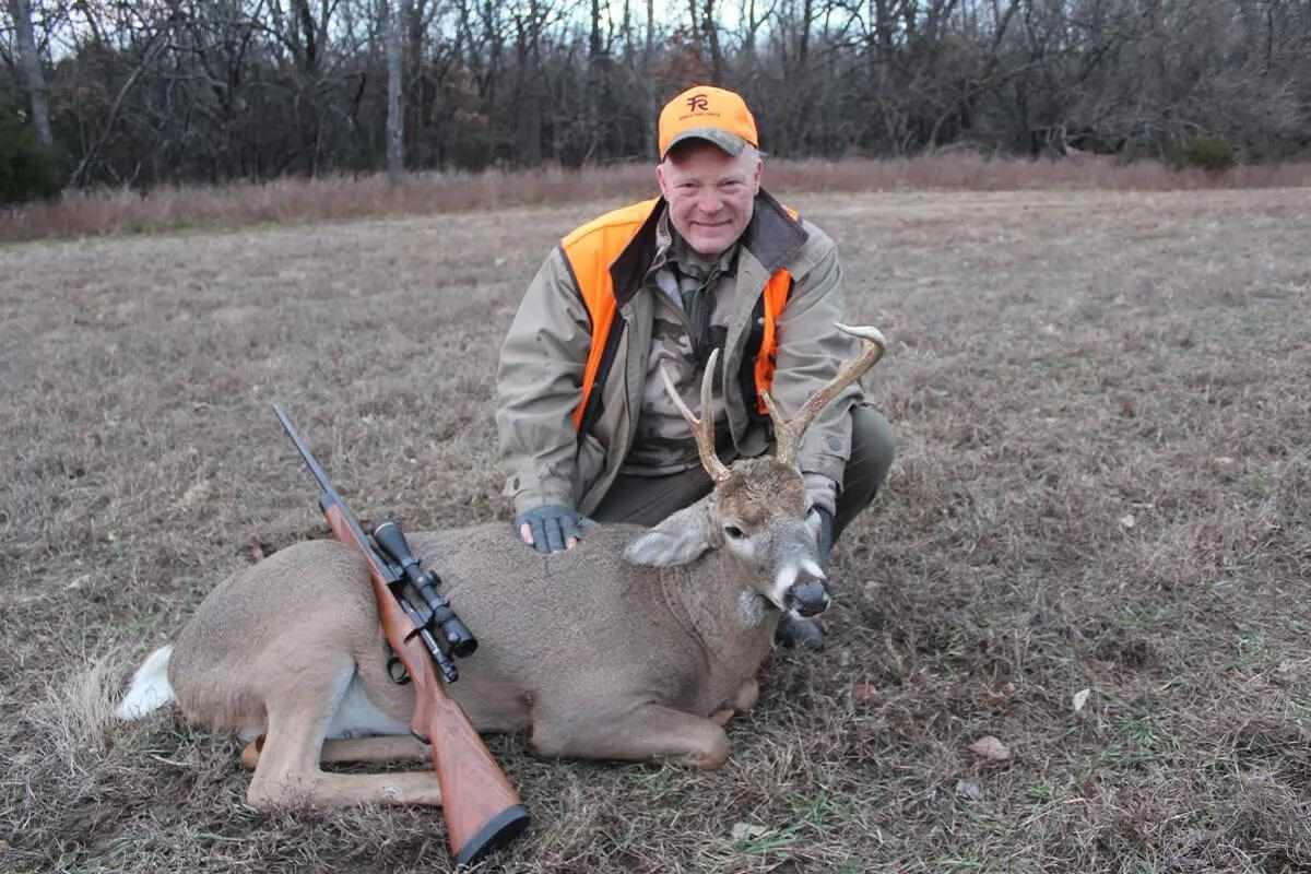 hunter with whitetail buck